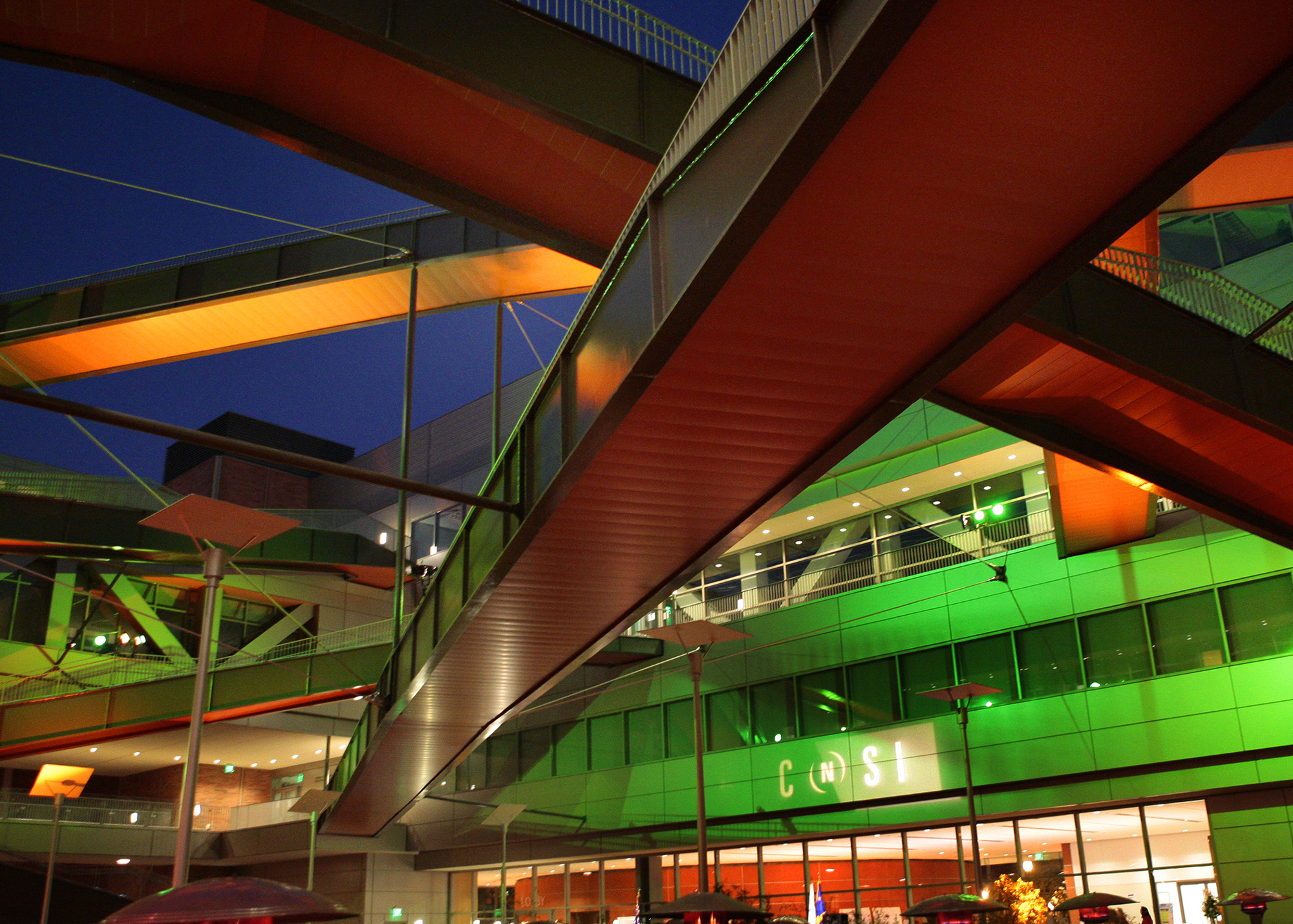 UCLA's California NanoSystems Institute lit up green at night time for the opening. 