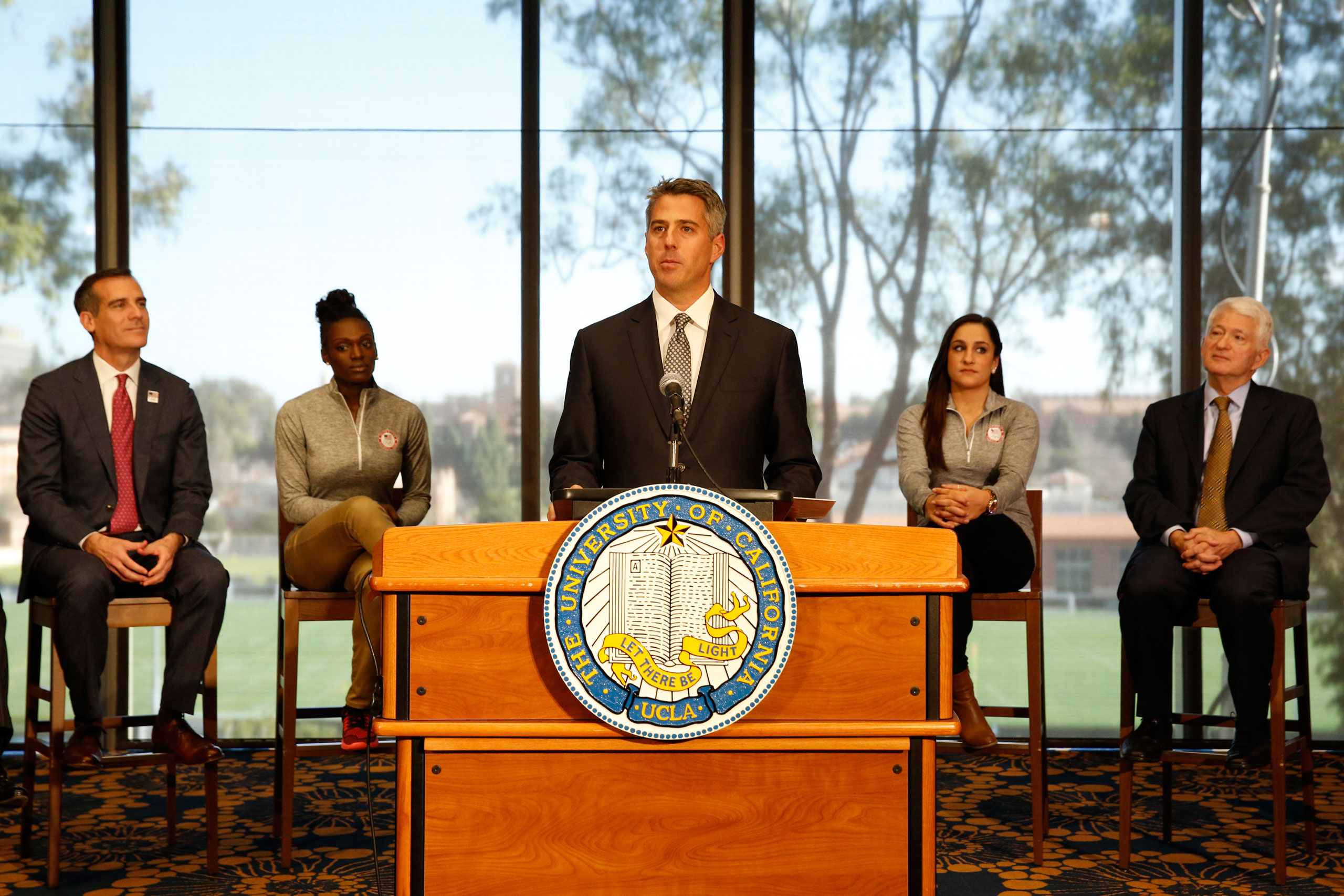 Garcetti, Nelson, Wieber, and Chancellor Block sit on stage, focusing on Wasserman as he speaks from behind a podium in the foreground.