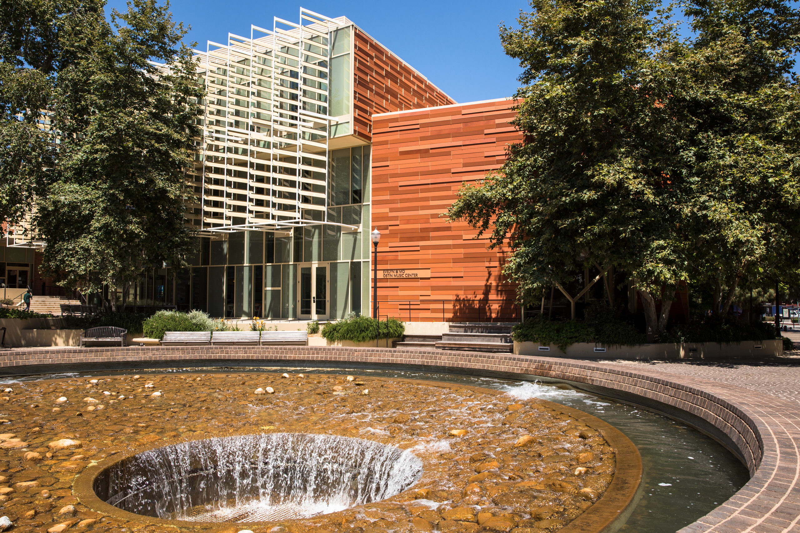 An exterior shot of the Evelyn and Mo Ostin Music Center, and the inverted fountain, on.a sunny day. 