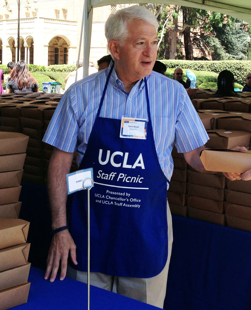 Chancellor Block hands out a sandwich at the staff picnic in 2014.
