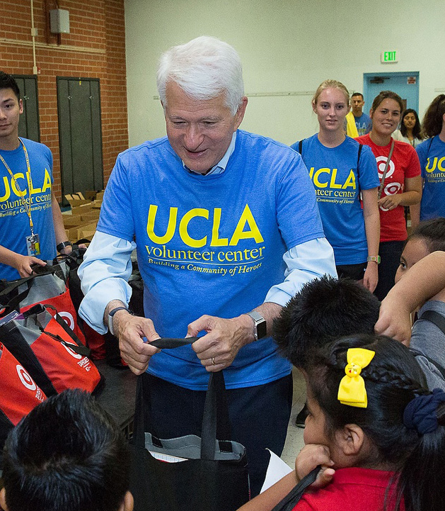 Chancellor Block handing out backpacks to students at Volunteer Day in 2016. 
