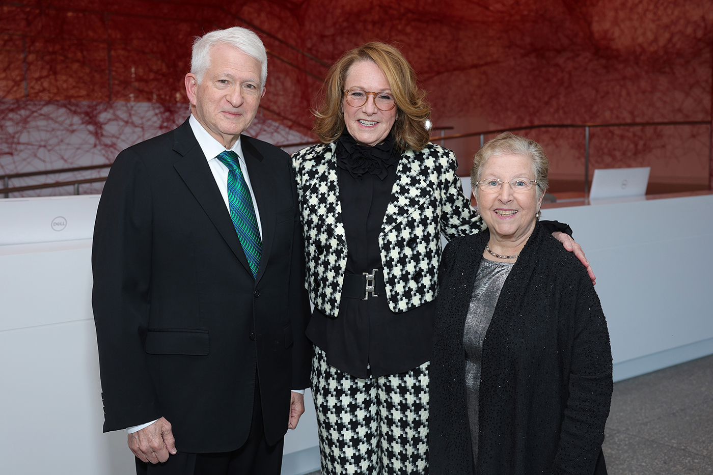 Chancellor Block and Mrs. Block flank a blonde woman wearing a houndstooth suit in the entryway of the Hammer Museum.